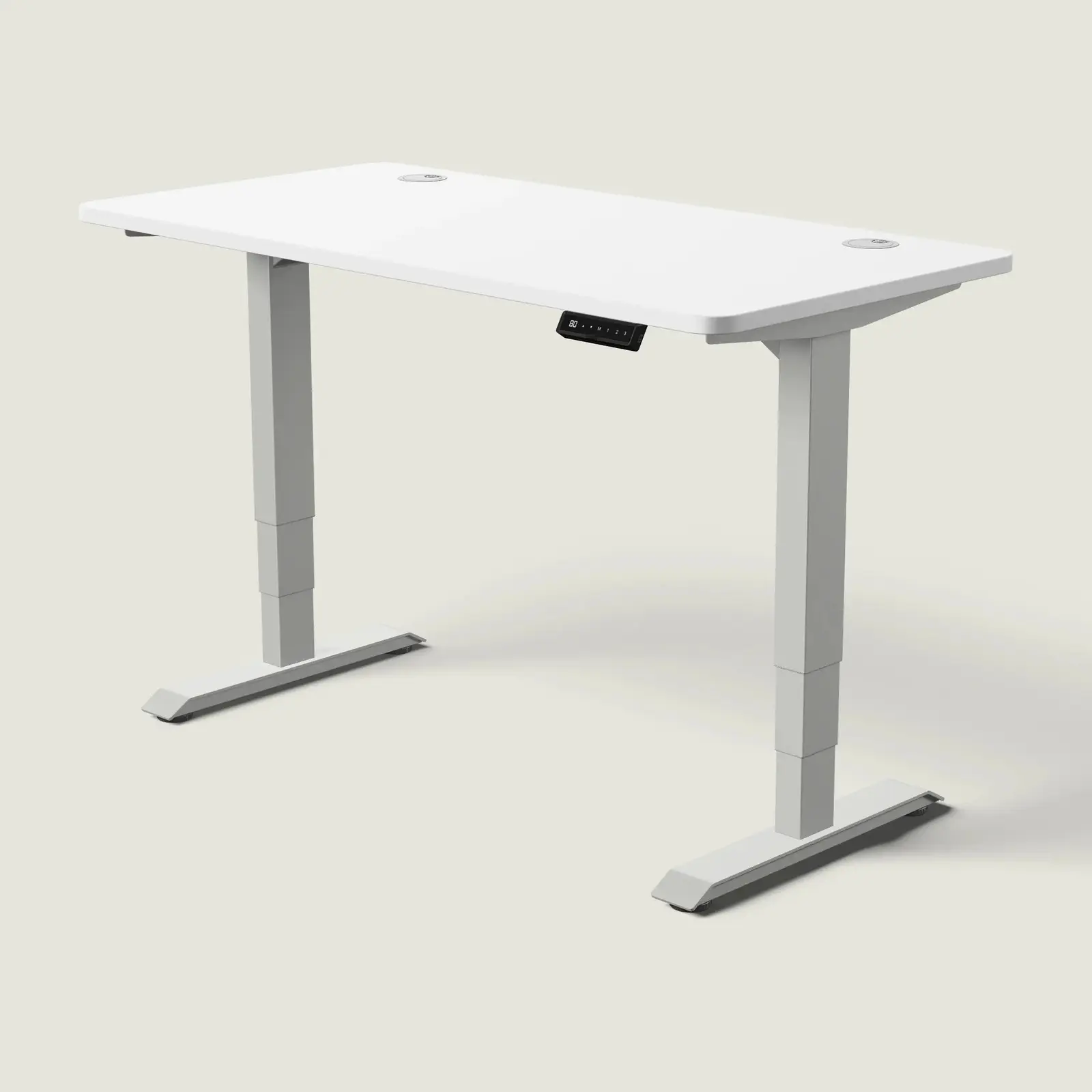 Electric standing desk, 140 × 70 cm, grey frame and white top, with the memory handset under the front edge, on a pale grey background