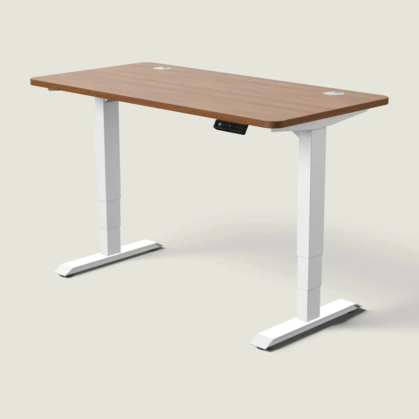 Electric standing desk, 140 × 70 cm, white frame and walnut-effect top, with the memory handset under the front edge, on a pale grey background