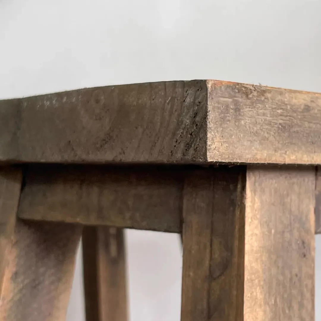 Close-up of the edge of a rustic fir wood stool seat