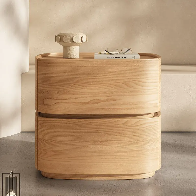 Curved two-drawer bedside table in a natural wood finish, seen from the front
