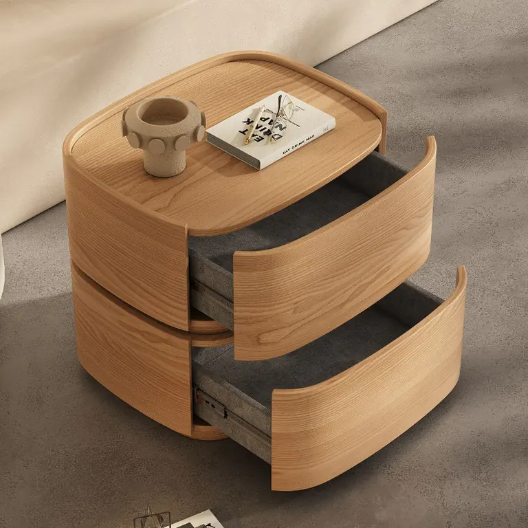 Curved bedside table in a natural wood finish with both drawers open